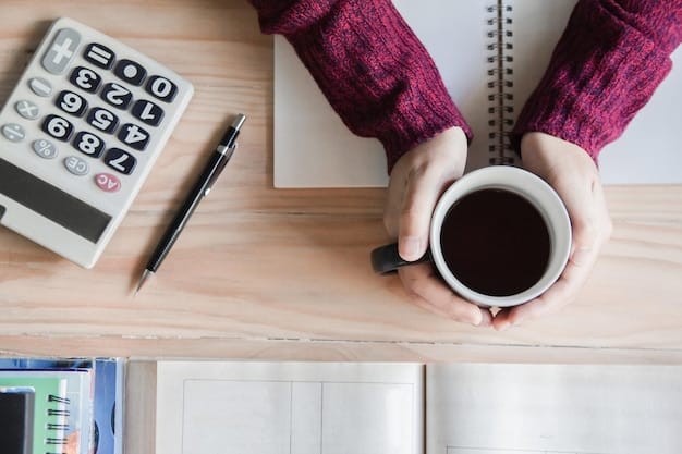 A close-up shot of a hand writing in a budget planner, with a calculator and a coffee cup on the desk. The focus is on the act of planning and organizing finances.