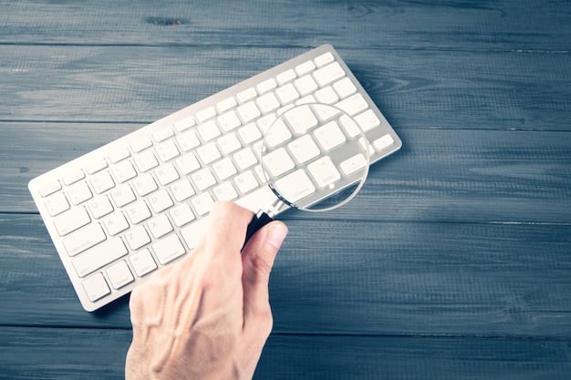 A hand hovering over a laptop keyboard, with a magnifying glass focusing on the address bar of the browser, highlighting the importance of verifying website URLs.