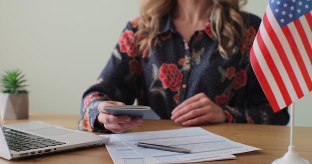 A close-up of a hand holding a pen over a tax form, surrounded by a calculator, financial documents, and a small American flag.