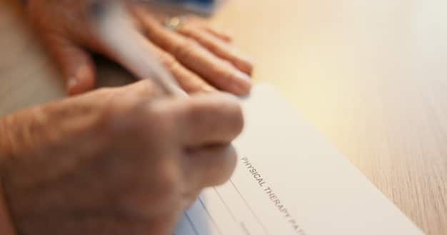 A close-up of a donor's hand writing a check payable to a charitable organization, with focus on the check details and a subtle background of financial documents.