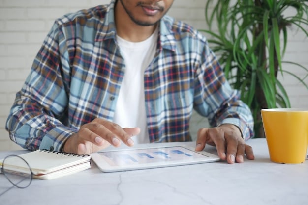 A person looking at a tablet displaying various financial charts and graphs, with a calculator and notepad nearby, representing careful financial planning and debt management.