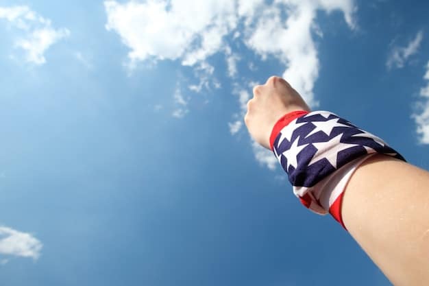 A close up of a hand holding an American flag with the US Capitol building blurred in the background. The light is slightly overcast, giving the image a serious yet hopeful tone.