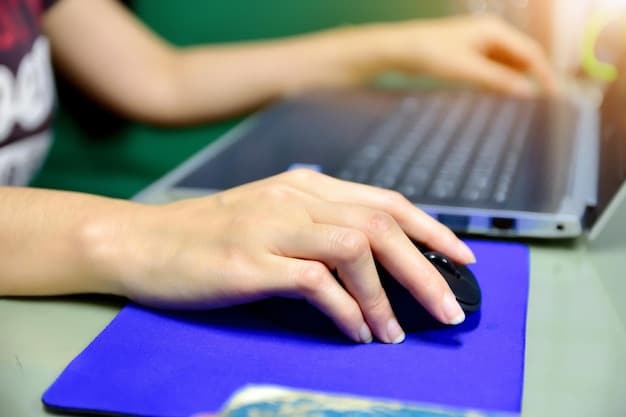 A close-up shot of a student's hands typing on a laptop keyboard, focusing on the fingers pressing keys related to scholarship search terms.