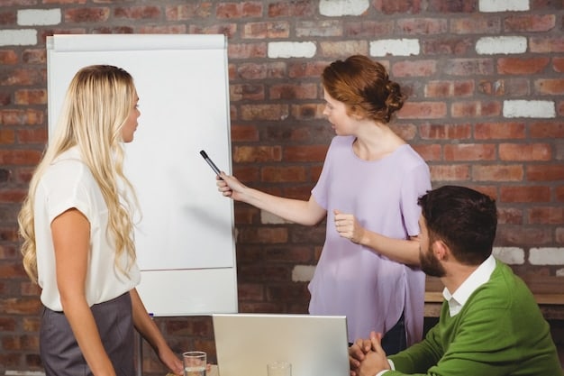 A young woman confidently presenting a project to her team in a brightly lit office, illustrating the communication and presentation skills honed during an internship.