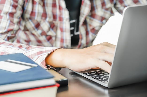 A close-up shot of a student typing on a laptop in a modern office environment, emphasizing the development of technical skills and attention to detail during an internship.