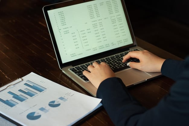 A close-up of a person's hands typing on a laptop, with a spreadsheet visible on the screen showing cryptocurrency transactions and calculations.