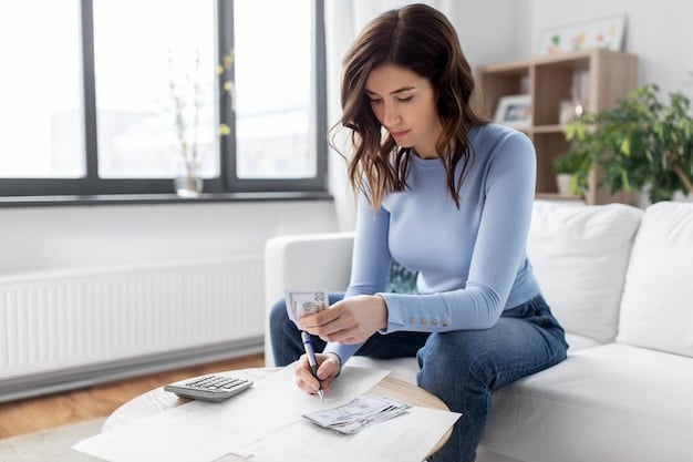 A person holding a property tax bill while using a calculator to determine tax deductions.
