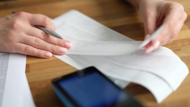 Close-up shot of a hand filling out a tax form with the words 