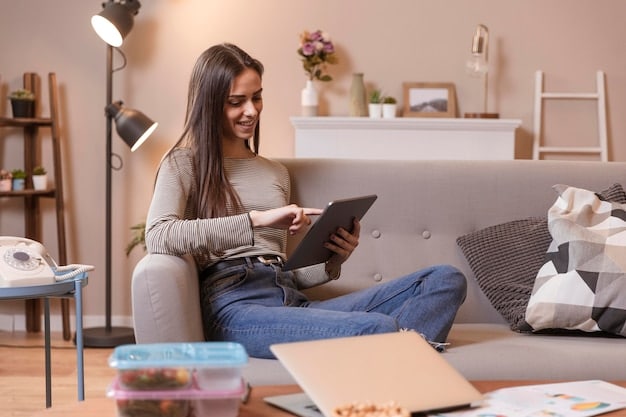 A person smiling while using tax software on a tablet. The background shows a comfortable living room setting, emphasizing the convenience and ease of filing taxes online.