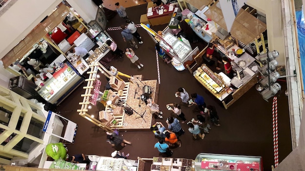 A collage of images showcasing various sectors affected by decreased consumer spending, including retail stores with fewer customers, empty restaurant tables, and a factory with idle machinery.