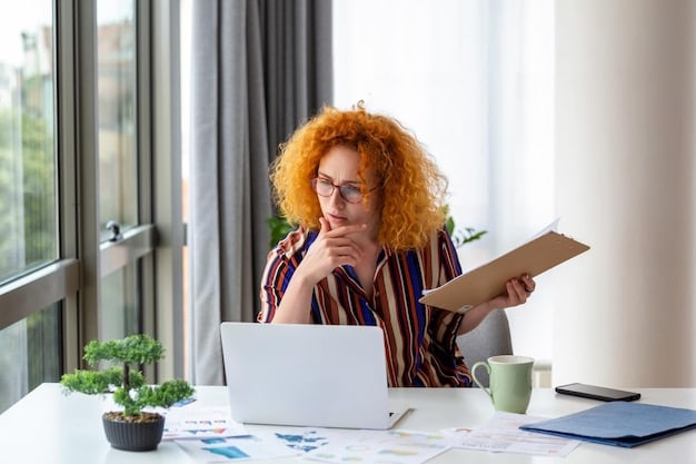 A person sitting at a desk, looking at a laptop with financial documents scattered around, with a thoughtful expression.