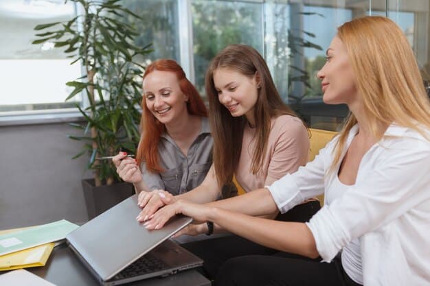 A young woman confidently presenting a project to her team in a brightly lit office. She is gesturing towards a whiteboard with data charts, showcasing her skills and contributions during her internship.