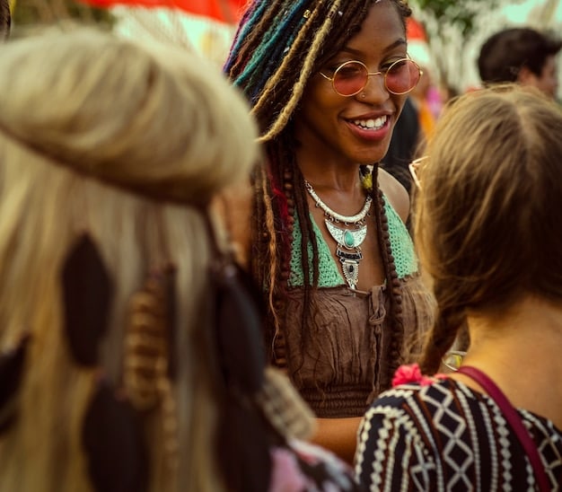 A student participating in a cultural festival in a foreign country, wearing traditional clothing and interacting with locals, showcasing cultural immersion during a study abroad program.
