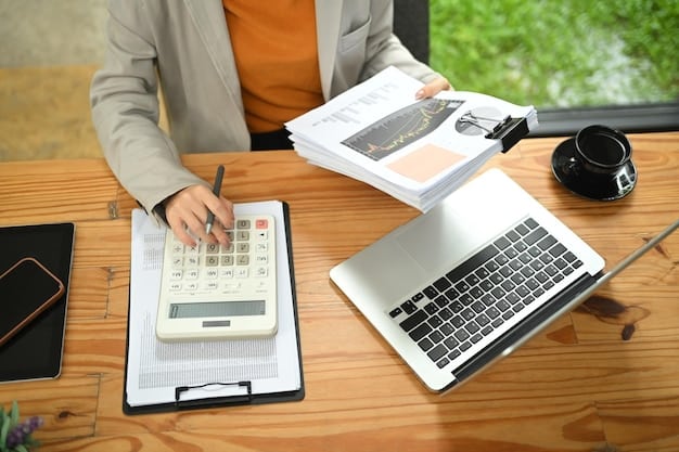 A person organizing receipts and tax documents at their desk, with a laptop displaying a tax form and a calculator nearby, symbolizing financial organization and tax preparation.