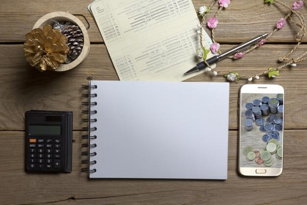 An overhead shot of a workspace showing a notebook, pen, receipts, and a calculator representing expense management.